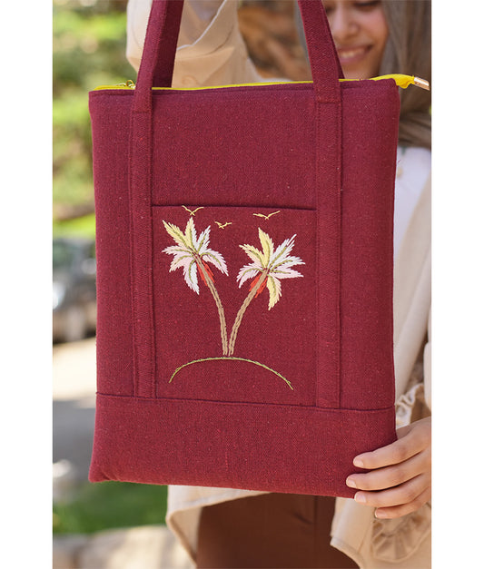 Burgundy Embroidered Palm Linen Padded Laptop Bag handmade in Egypt & available at Jozee Boutique.handmade in Egypt & available at Jozee Boutique.