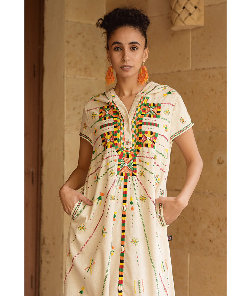 Off white Siwa Heavily Embroidered Linen Dress with Hoodie handmade in Egypt & available at Jozee Boutique.