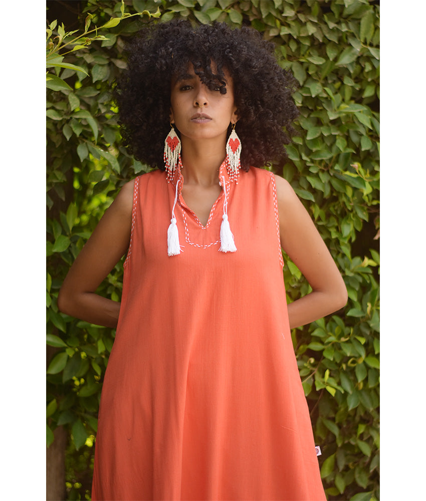 Orange Linen Dress with Ancient Egyptian Lotus Embroidery handmade in Egypt & available at Jozee Boutique.