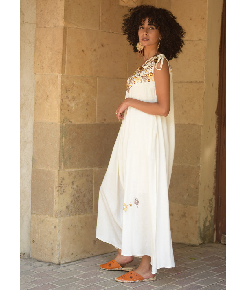 White Siwa Embroidered Linen Flowy Jumpsuit/Dress handmade in Egypt & available at Jozee Boutique.