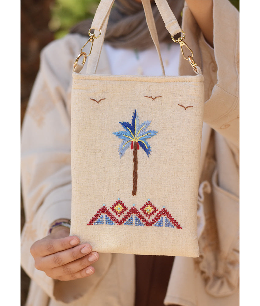 Off white Embroidered Palm Linen Cross Bag handmade in Egypt & available at Jozee Boutique.handmade in Egypt & available at Jozee Boutique.