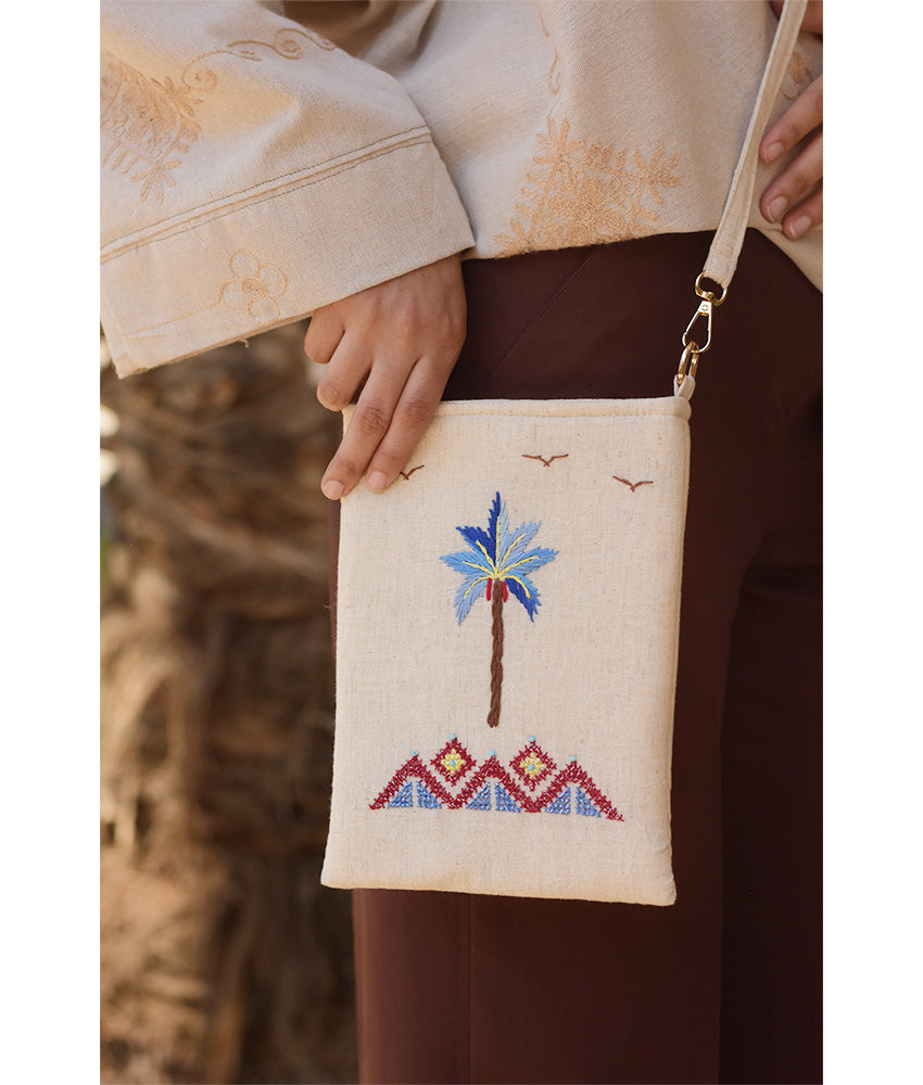 Off white Embroidered Palm Linen Cross Bag handmade in Egypt & available at Jozee Boutique.handmade in Egypt & available at Jozee Boutique.