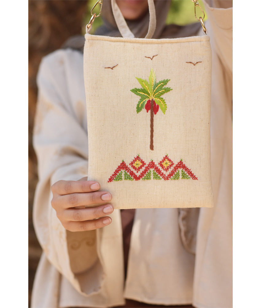 Off white Embroidered Palm Linen Cross Bag handmade in Egypt & available at Jozee Boutique.handmade in Egypt & available at Jozee Boutique.