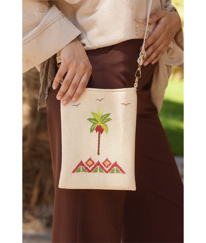 Off white Embroidered Palm Linen Cross Bag handmade in Egypt & available at Jozee Boutique.handmade in Egypt & available at Jozee Boutique.