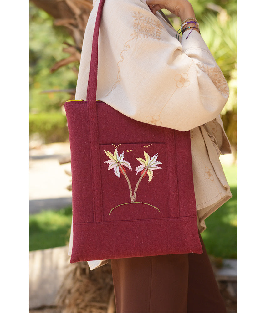 Burgundy Embroidered Palm Linen Padded Laptop Bag handmade in Egypt & available at Jozee Boutique.handmade in Egypt & available at Jozee Boutique.