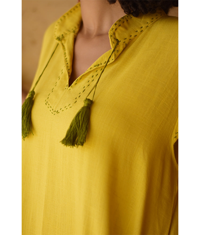 Yellow Linen Dress with Ancient Egyptian Lotus Embroidery handmade in Egypt & available at Jozee Boutique.