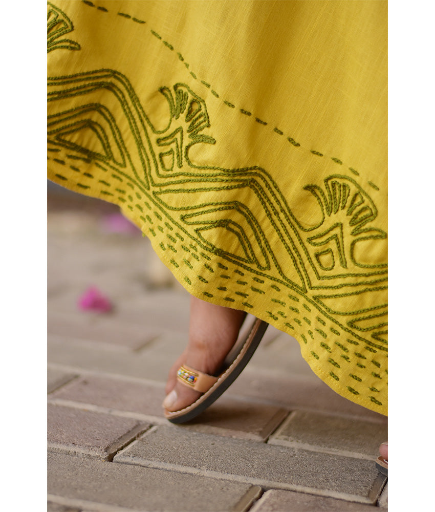 Yellow Linen Dress with Ancient Egyptian Lotus Embroidery handmade in Egypt & available at Jozee Boutique.