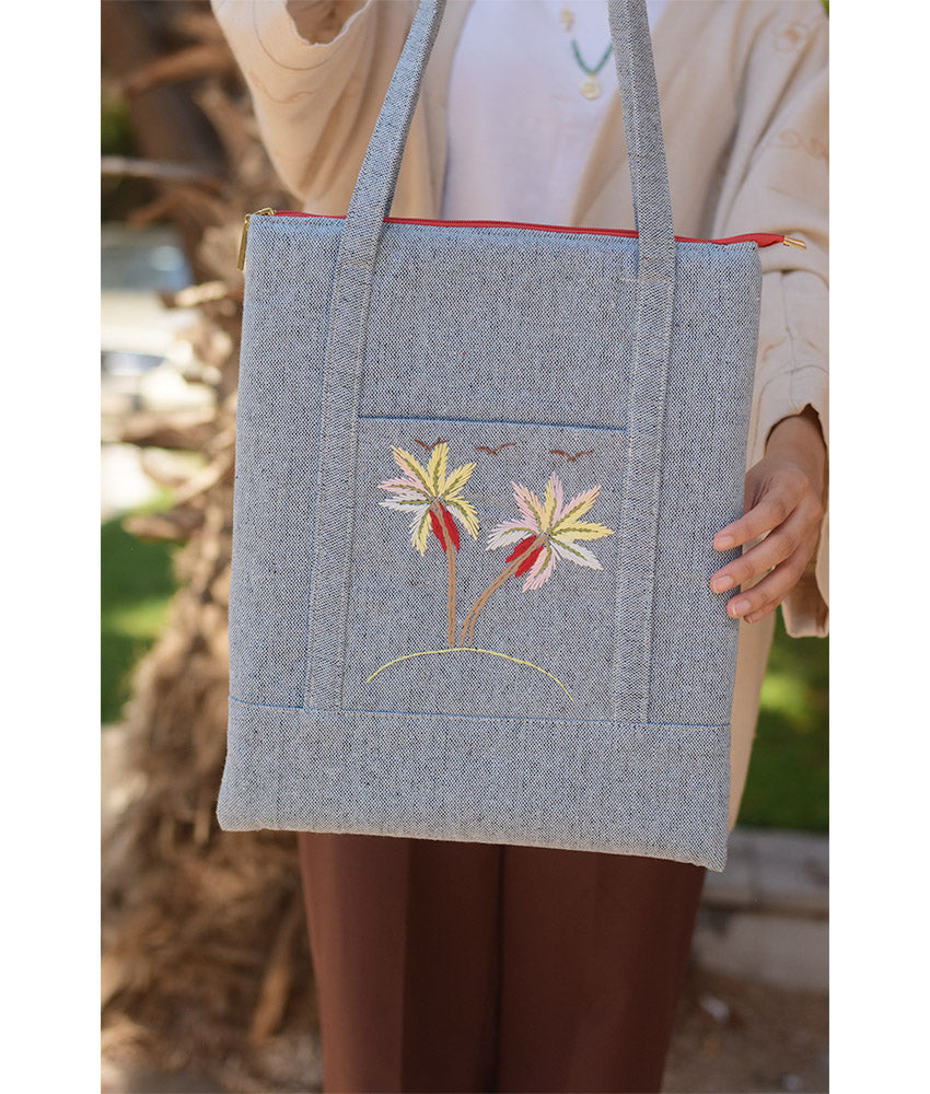 Light grey Embroidered Palm Linen Padded Laptop Bag handmade in Egypt & available at Jozee Boutique.handmade in Egypt & available at Jozee Boutique.