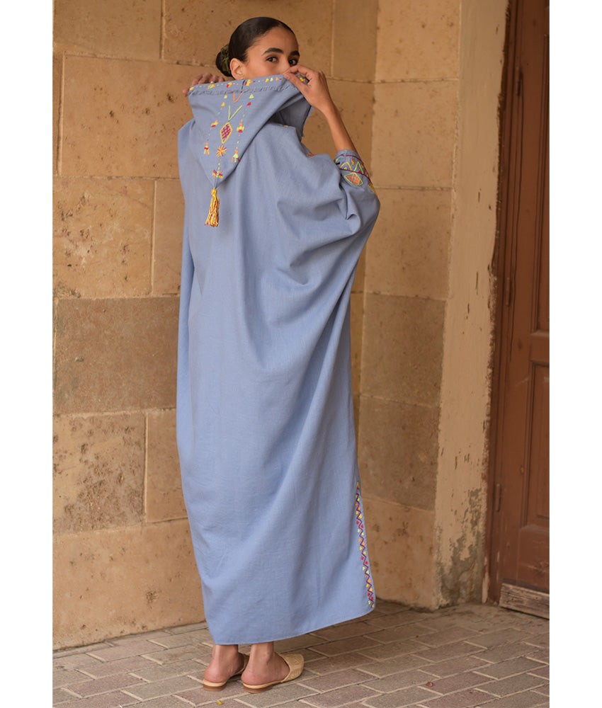 Denim blue Siwa Heavily Embroidered Linen Kaftan with Hoodie handmade in Egypt & available at Jozee Boutique.