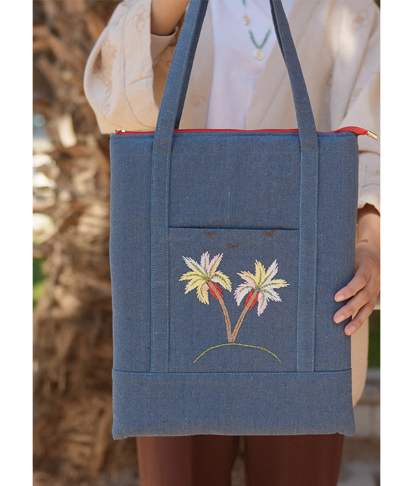 Denim blue Embroidered Palm Linen Padded Laptop Bag handmade in Egypt & available at Jozee Boutique.handmade in Egypt & available at Jozee Boutique.
