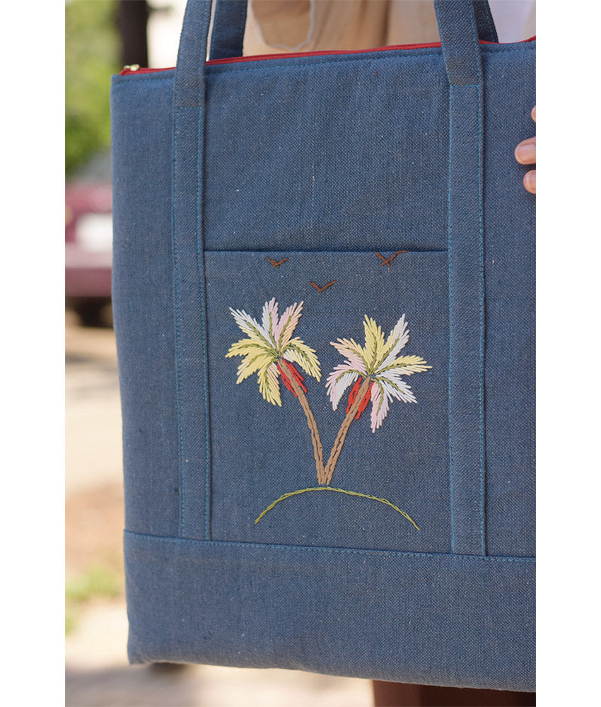 Denim blue Embroidered Palm Linen Padded Laptop Bag handmade in Egypt & available at Jozee Boutique.handmade in Egypt & available at Jozee Boutique.