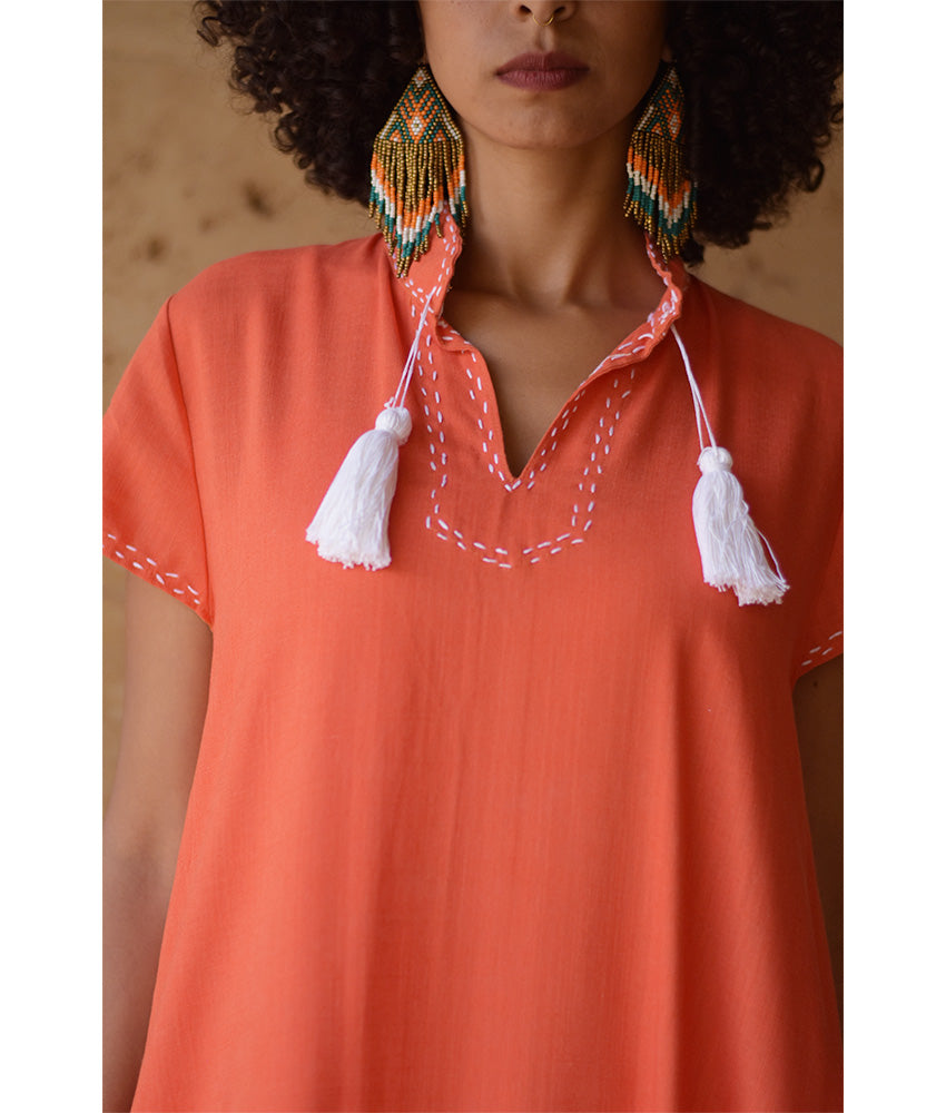 Orange Linen Dress with Ancient Egyptian Lotus Embroidery handmade in Egypt & available at Jozee Boutique.